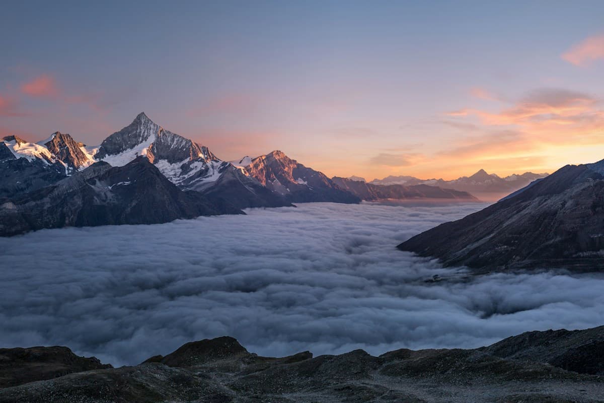 Backpackers on a mountain ridge at sunrise